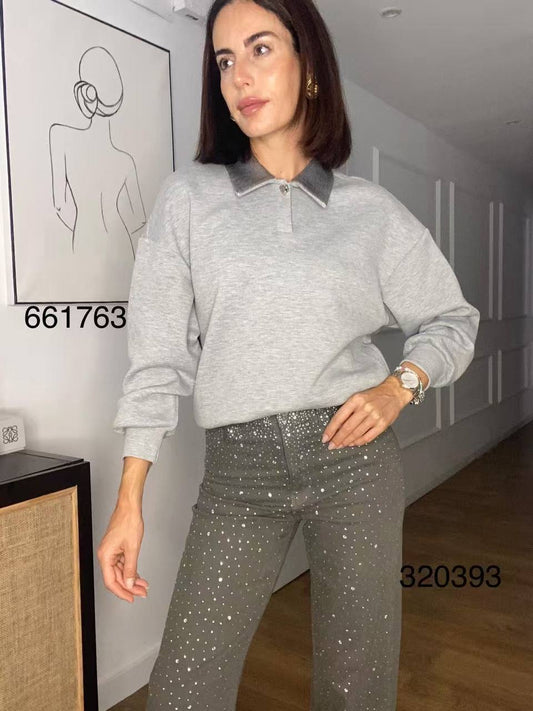 A jumper with a decorated collar.