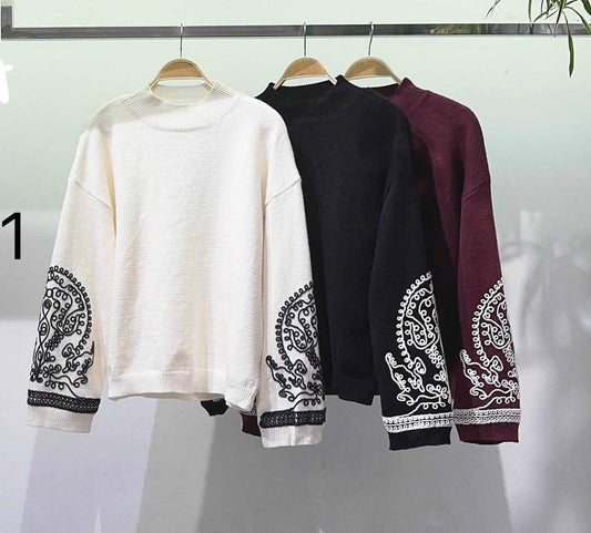 A jumper with detailing on the sleeves